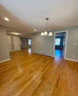 a bathroom with a granite countertop sink a toilet and mirror