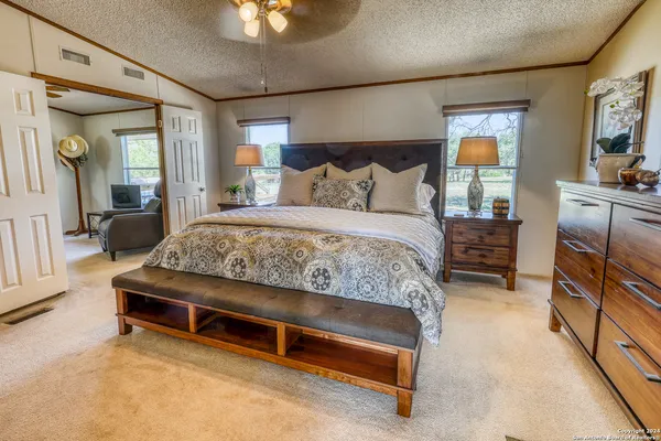 a bedroom with a bed and a chandelier