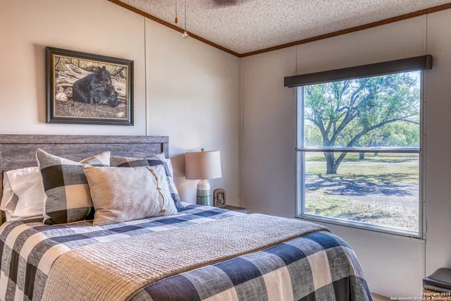 a bedroom with a large bed and a window