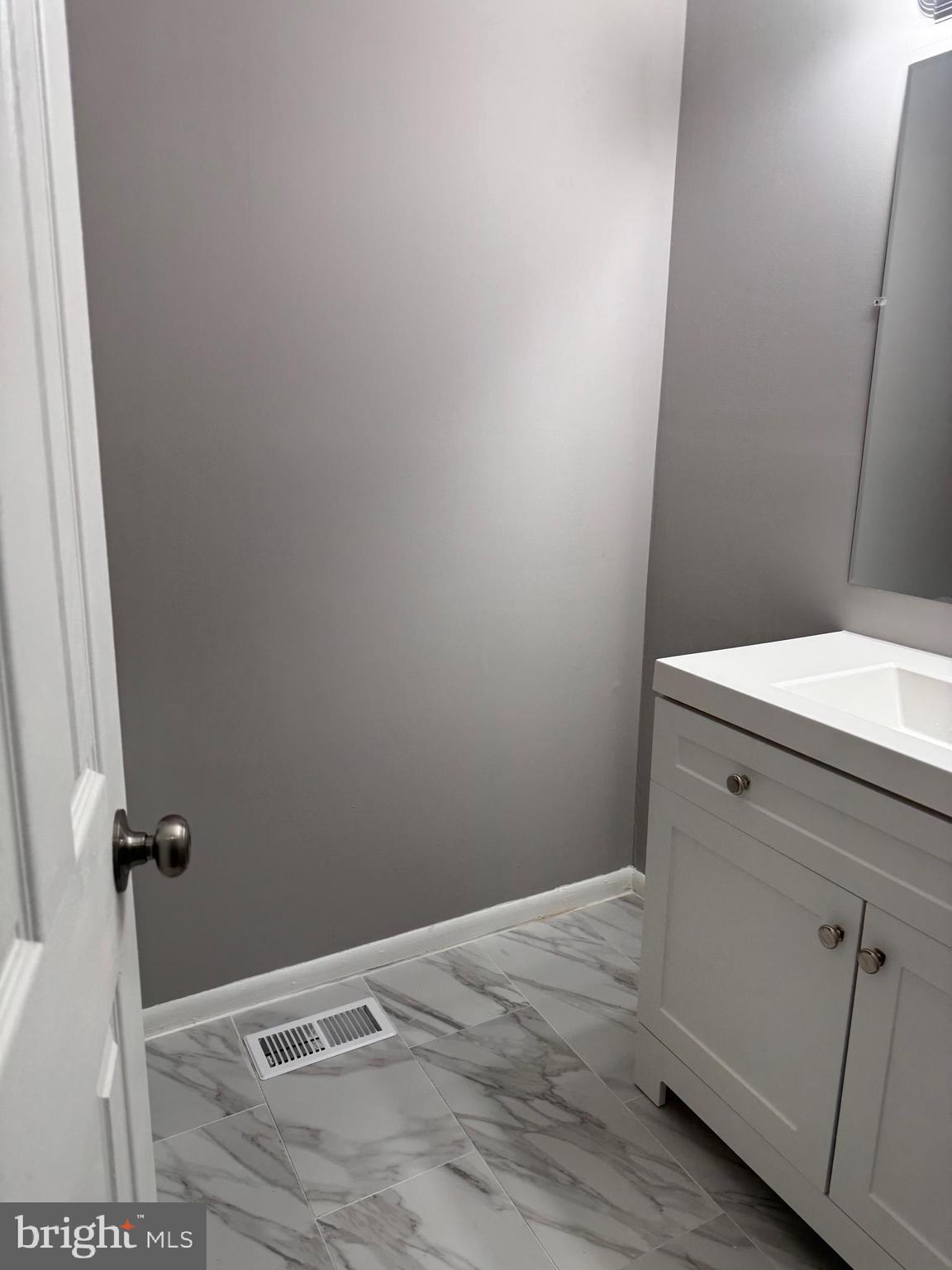 19970 Appledowre Circle, Unit 404 Germantown, MD 20876 - Photo 11 of 15 a view of a bathroom with a wooden floor