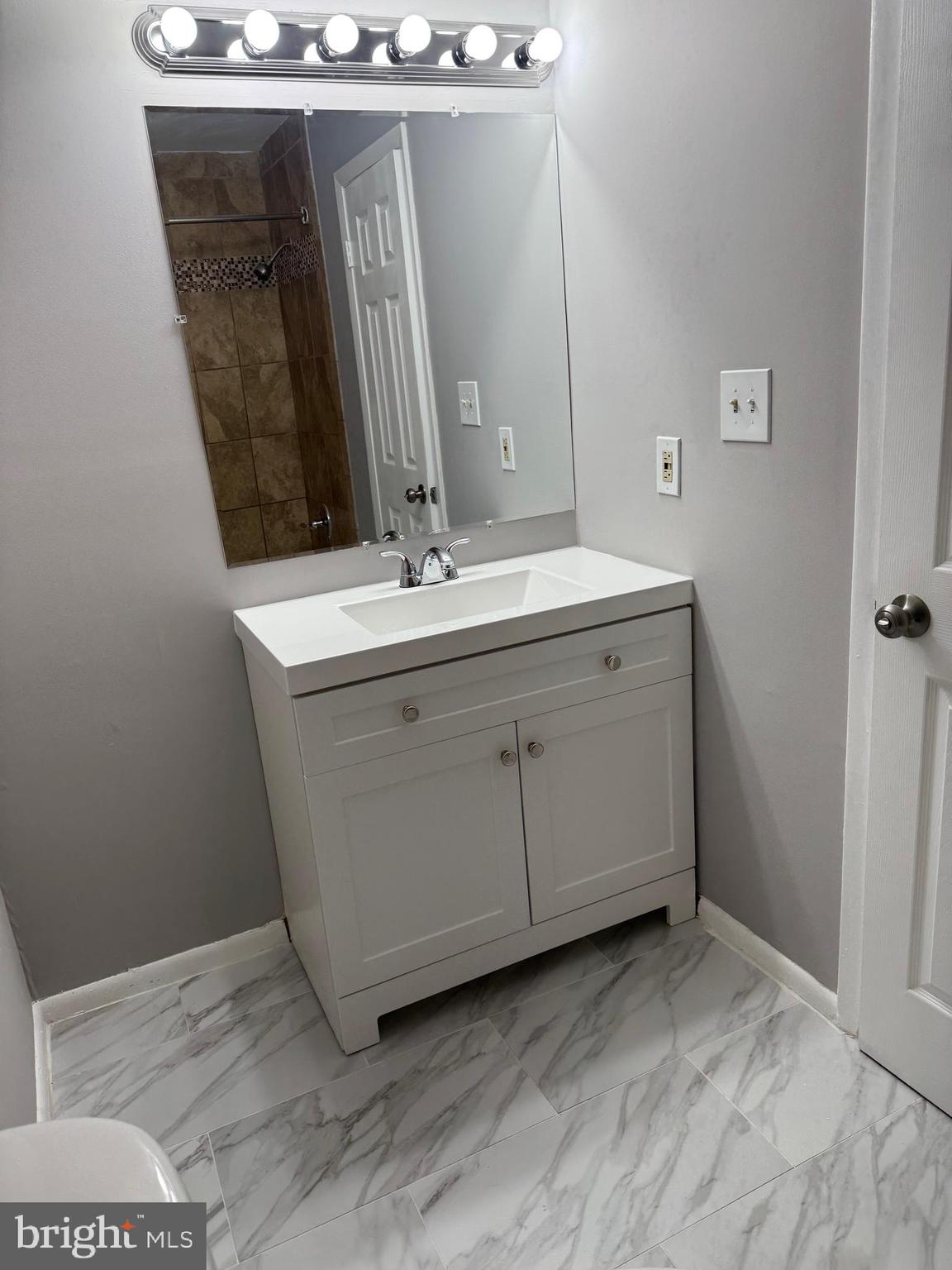 19970 Appledowre Circle, Unit 404 Germantown, MD 20876 - Photo 12 of 15 a bathroom with a sink and a mirror
