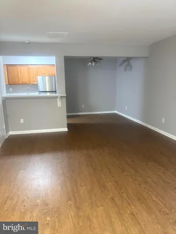 a view of a room with wooden floor and windows