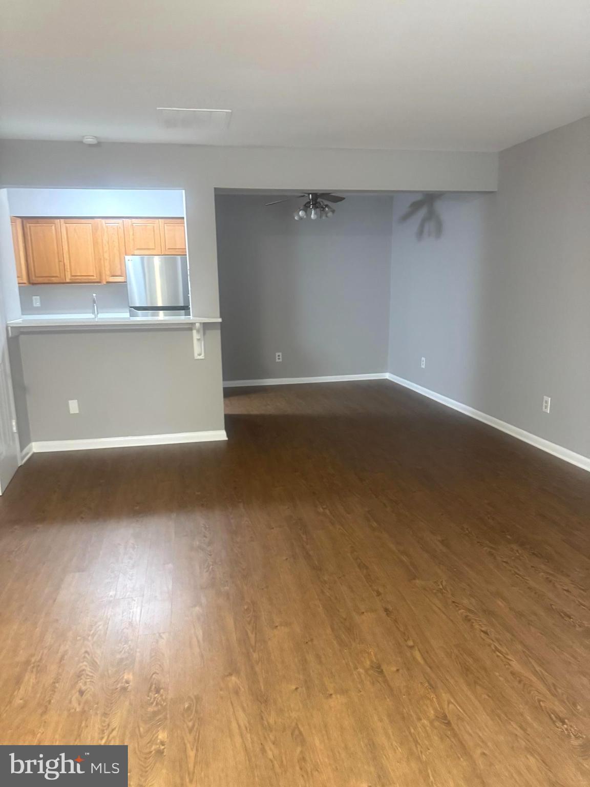19970 Appledowre Circle, Unit 404 Germantown, MD 20876 - Photo 13 of 15 a view of a room with wooden floor and windows