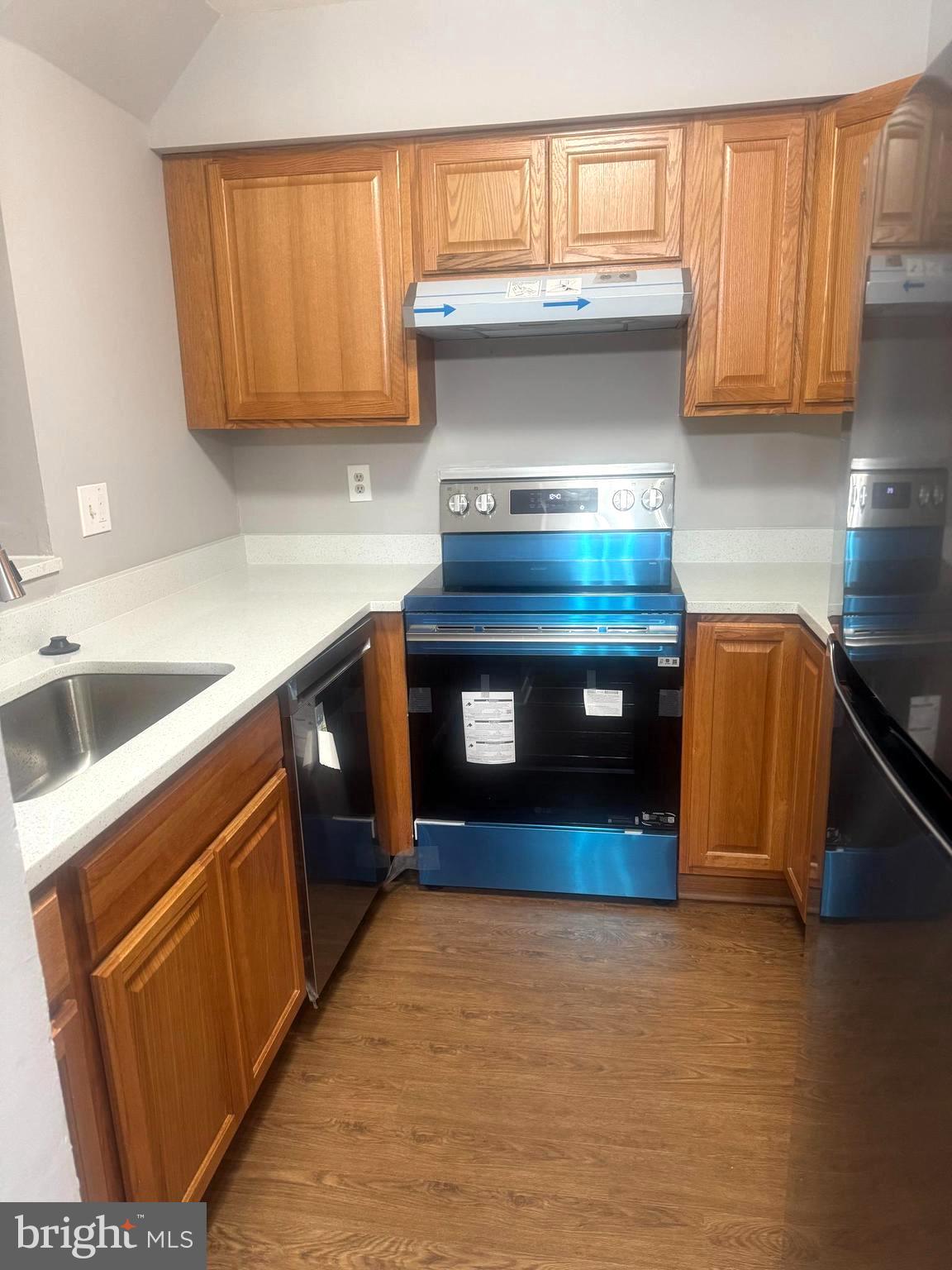 19970 Appledowre Circle, Unit 404 Germantown, MD 20876 - Photo 15 of 15 a kitchen with stainless steel appliances granite countertop a stove and a sink