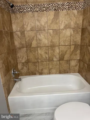 a bathroom with a bathtub and a toilet