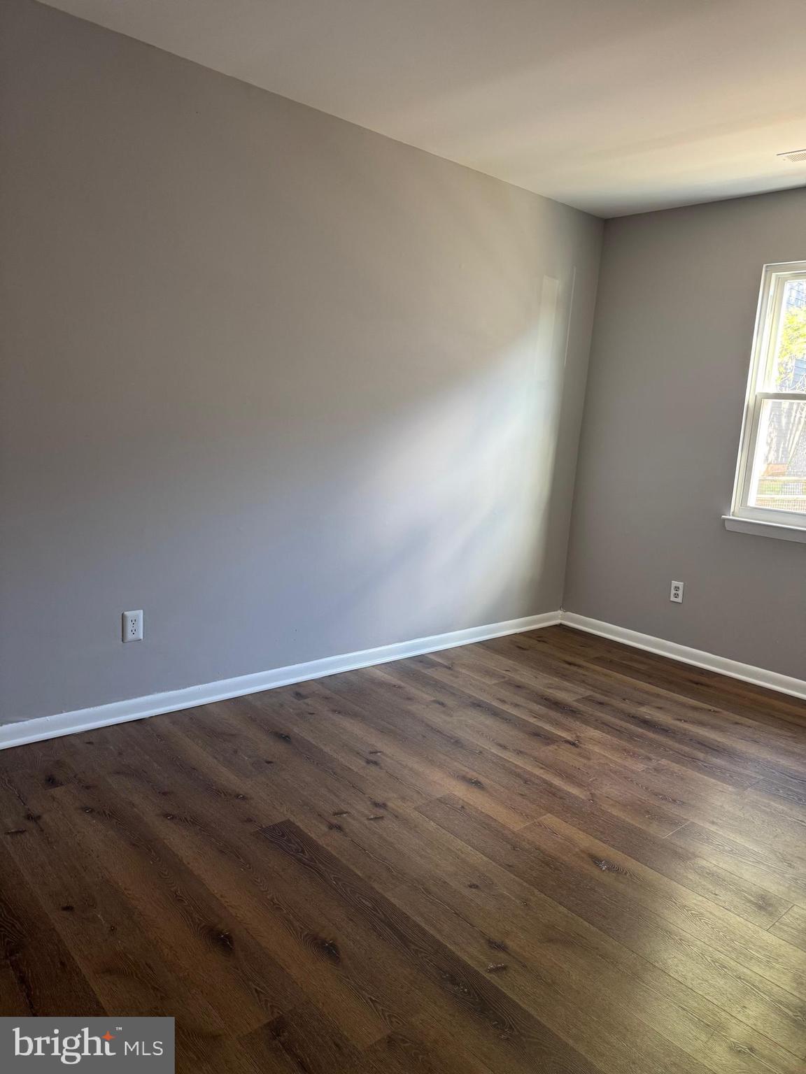 19970 Appledowre Circle, Unit 404 Germantown, MD 20876 - Photo 6 of 15 an empty room with wooden floor and windows