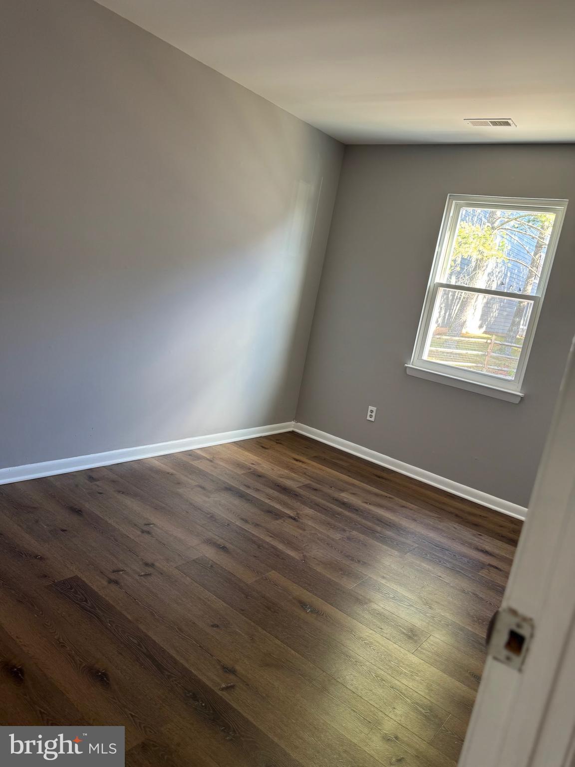 19970 Appledowre Circle, Unit 404 Germantown, MD 20876 - Photo 8 of 15 an empty room with wooden floor and windows