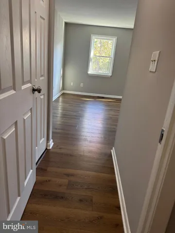 a view of an entryway with wooden floor