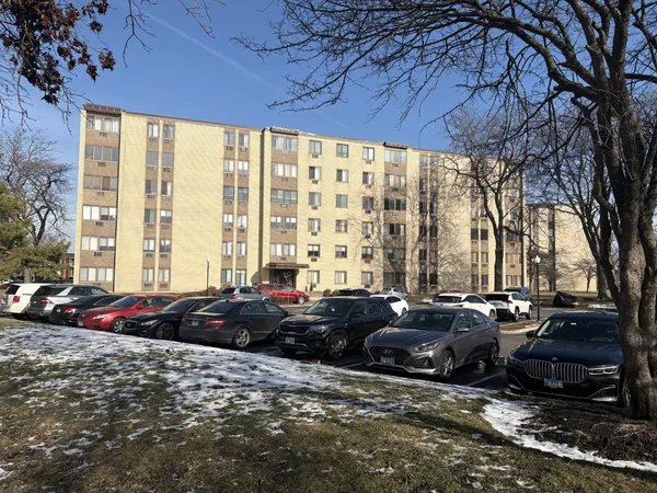 a couple of cars parked in front of a house