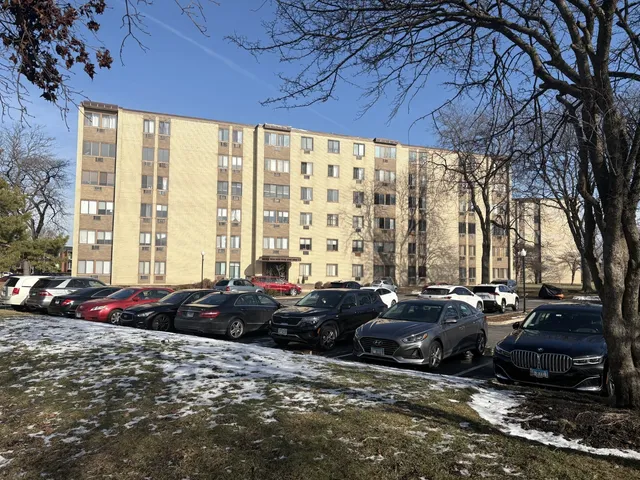 a couple of cars parked in front of a house