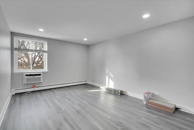 a view of an empty room with wooden floor