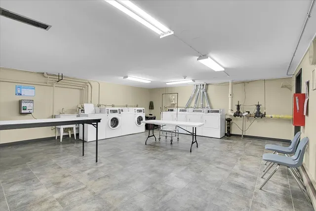 a living room with a washer and dryer