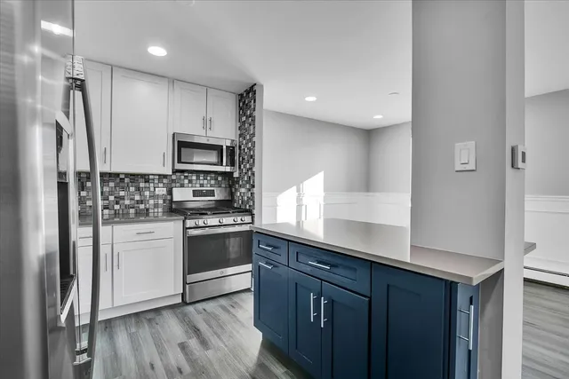 a kitchen with stainless steel appliances a refrigerator sink and stove