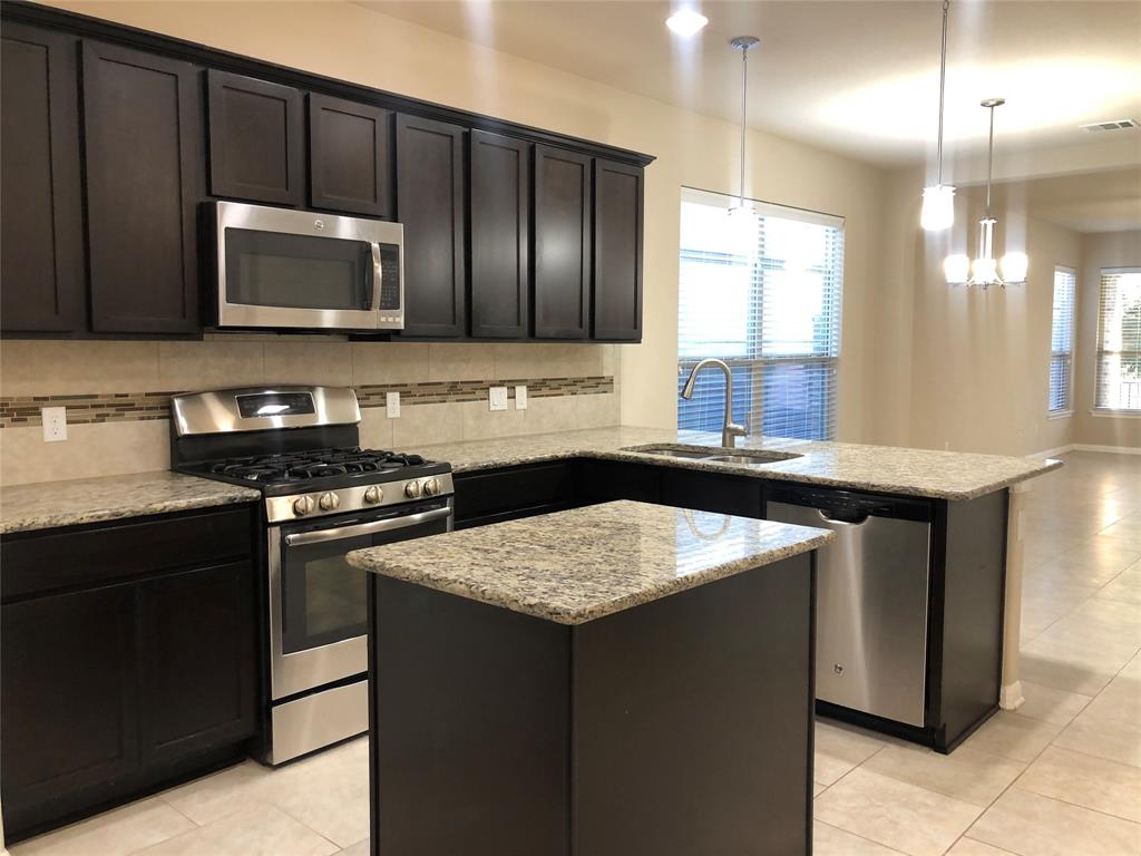 3451 Mayfield Ranch Boulevard, Unit 340 Round Rock, TX 78681 - Photo 3 of 13 Culinary delights await in this chef's kitchen, showcasing a suite of stainless steel appliances.