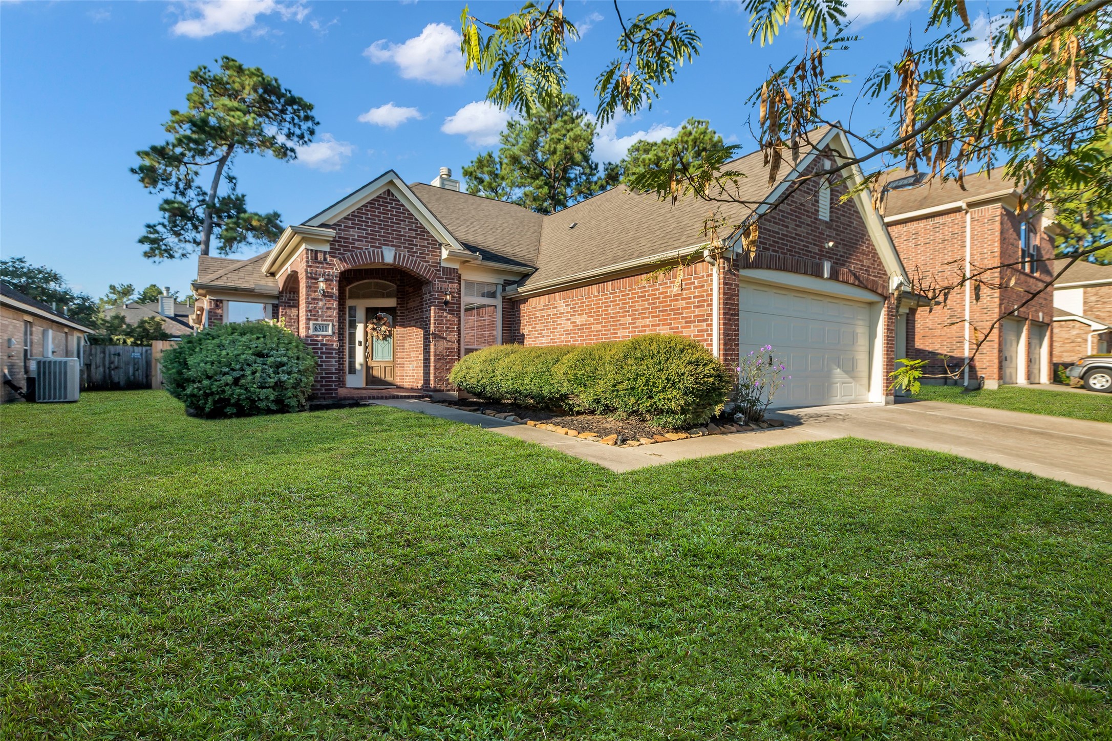 a front view of house with yard and green space