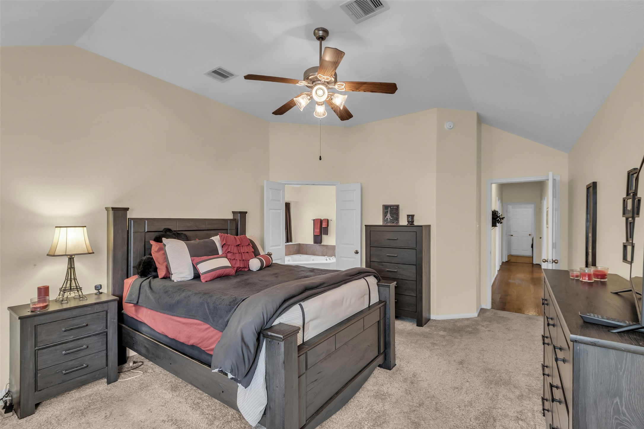 6311 Stone Hill Road Spring, TX 77389 - Photo 15 of 26 a bedroom with a bed and a chandelier