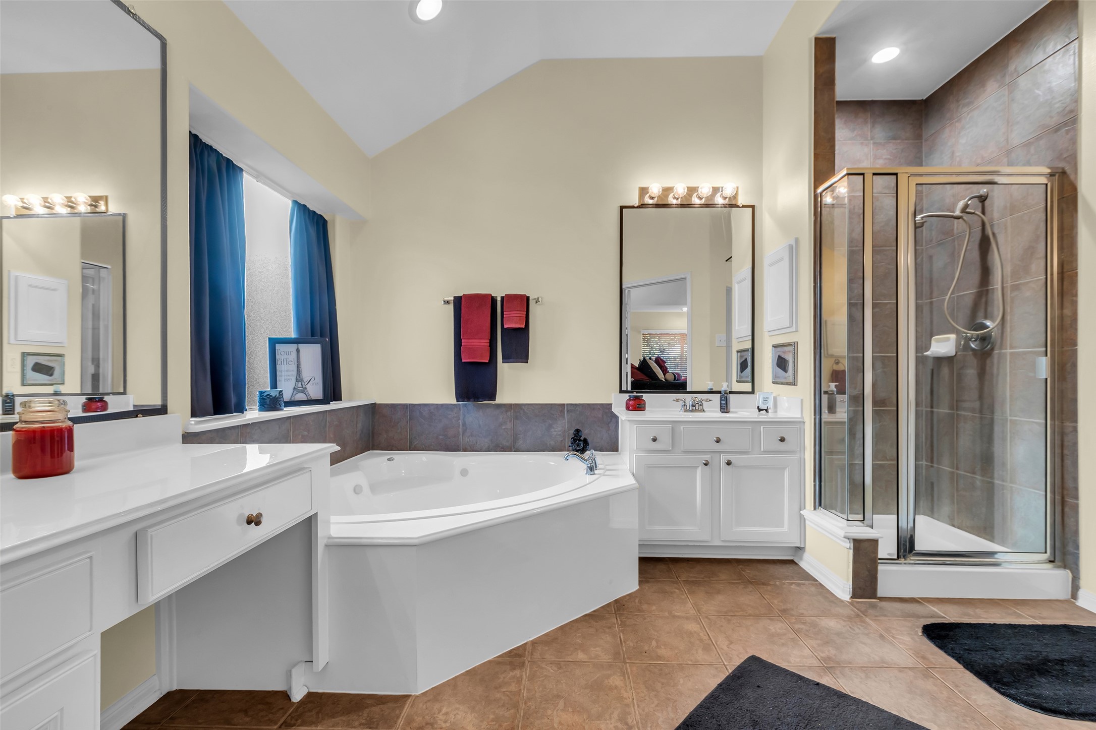 6311 Stone Hill Road Spring, TX 77389 - Photo 17 of 26 a bathroom with a tub a sink and a large mirror