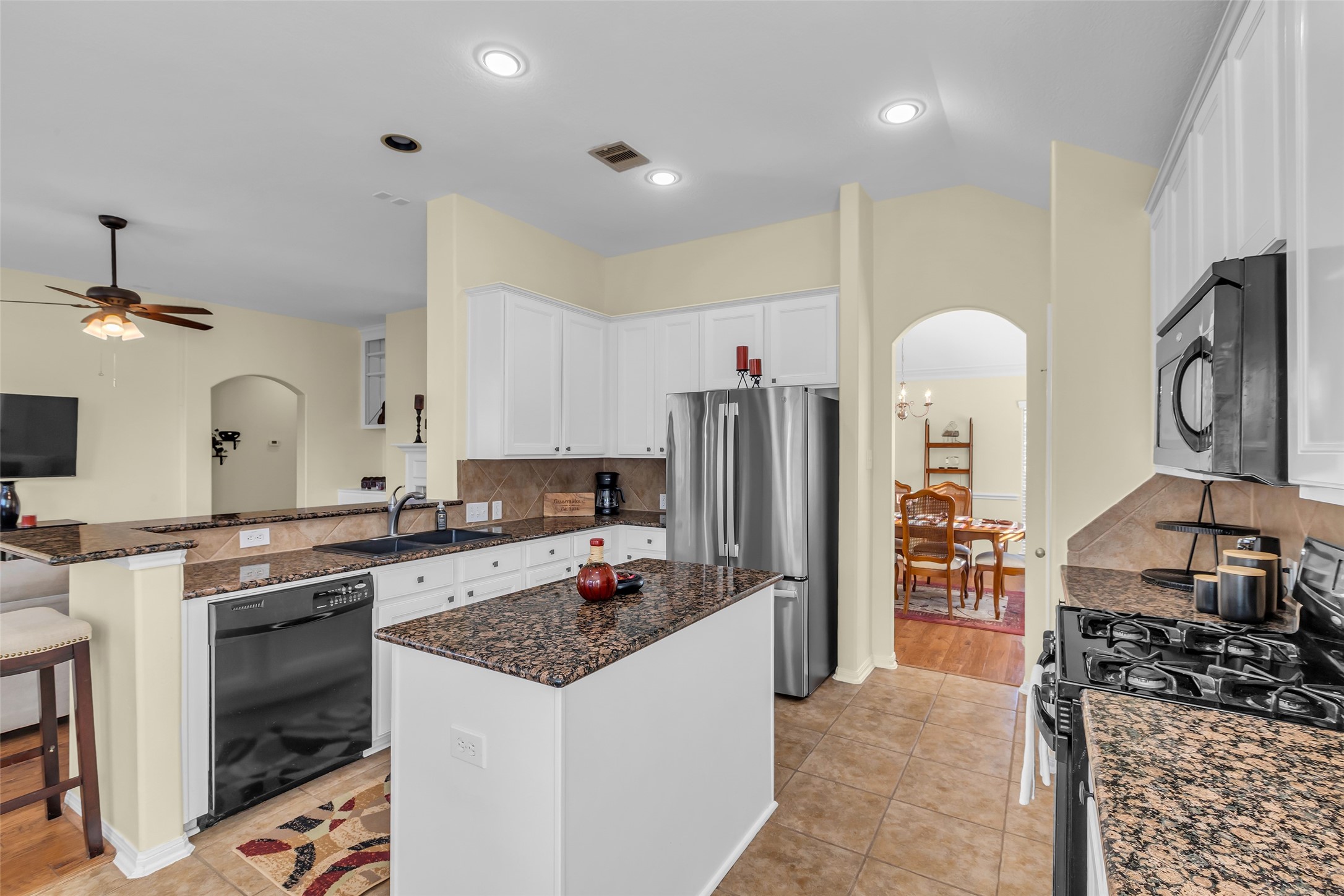 6311 Stone Hill Road Spring, TX 77389 - Photo 7 of 26 a kitchen with a stove and a refrigerator