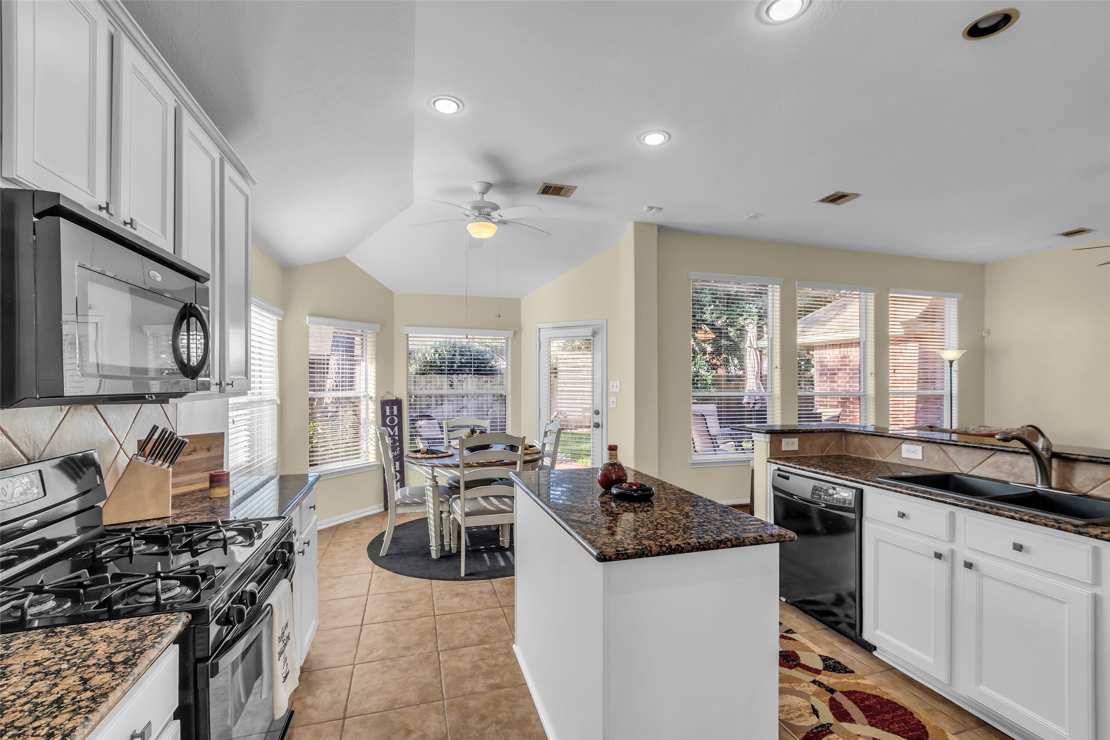 6311 Stone Hill Road Spring, TX 77389 - Photo 8 of 26 a kitchen with stainless steel appliances granite countertop a stove and a sink