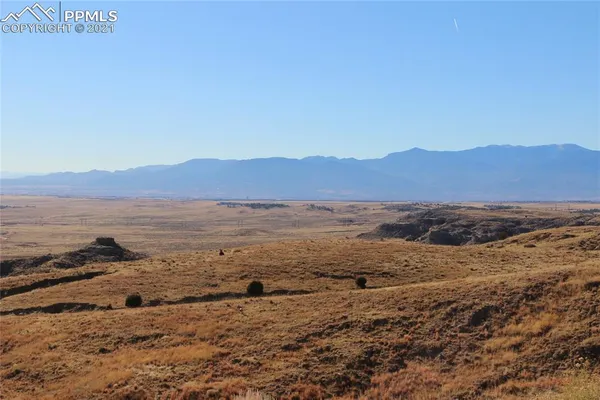 a view of a large mountain with mountains in the background
