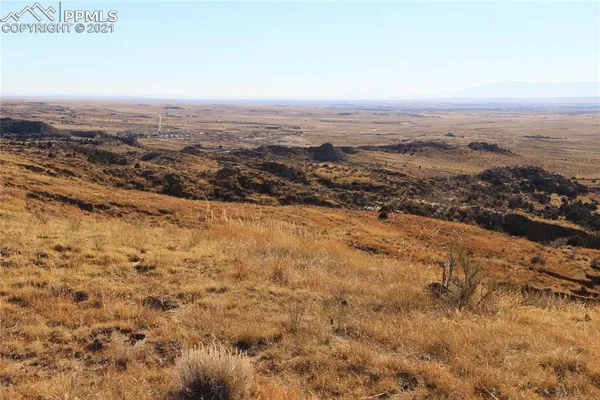 an aerial view of residential houses with city view
