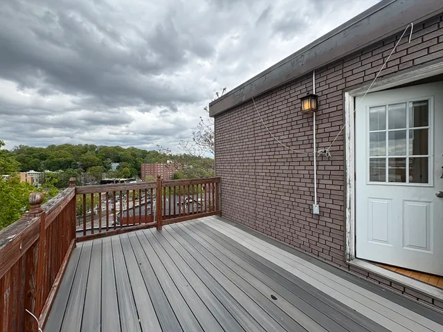 a view of a balcony with wooden floor