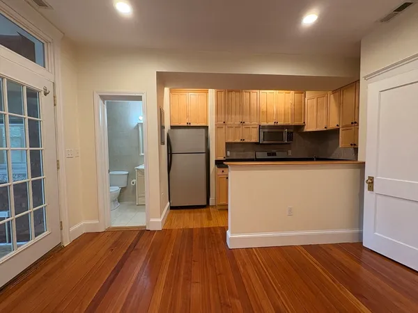 a kitchen with stainless steel appliances granite countertop a refrigerator a sink and a stove