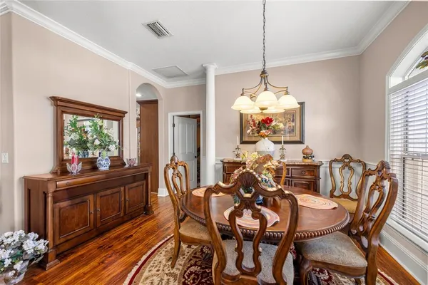 a view of a dining room with furniture window and wooden floor