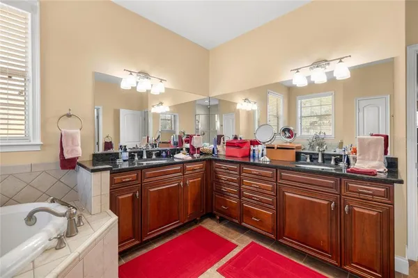a kitchen with granite countertop a sink cabinets and stainless steel appliances
