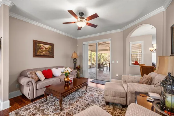 a living room with furniture a rug and a large window