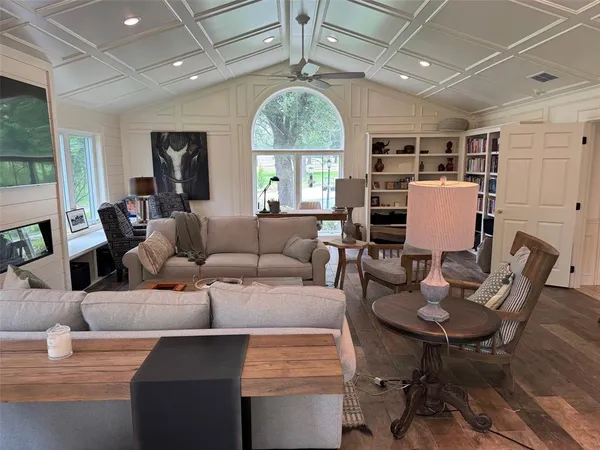 a living room with furniture a window and a chandelier