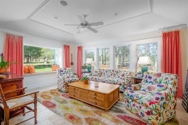 a living room filled with furniture and a large window