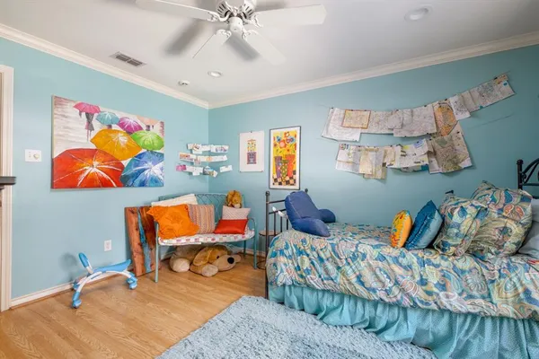 a bedroom with furniture and wooden floor