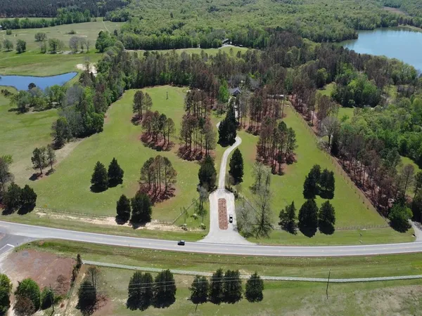 an aerial view of a residential houses with yard