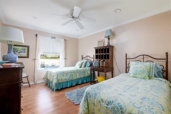 a bedroom with two beds and a chandelier