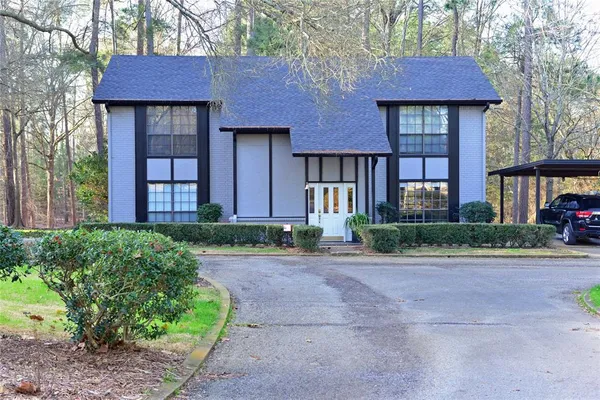 a front view of brick house with a yard