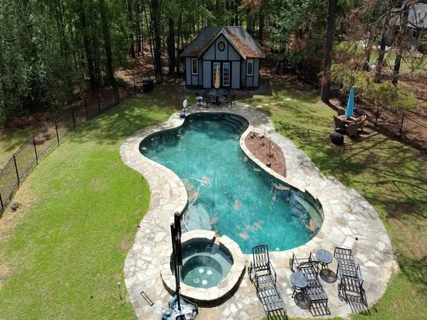 a view of a patio with table and chairs near an umbrella