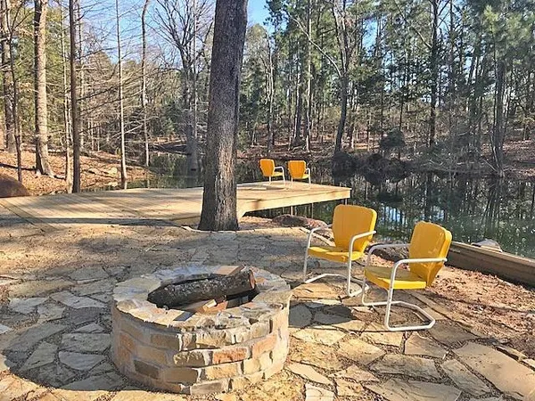 a backyard of a house with table and chairs
