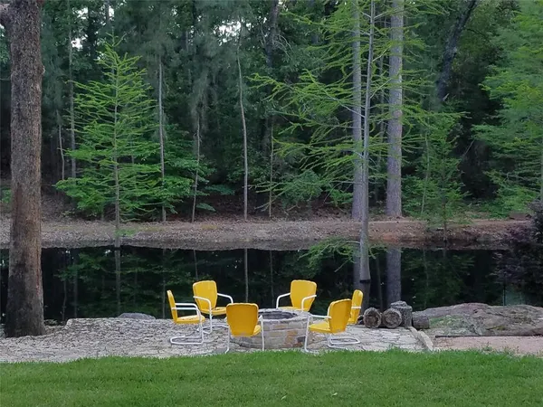 a view of a park with seating space and garden