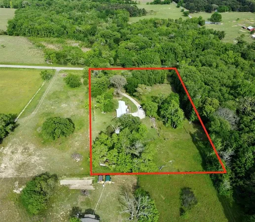 a view of a lake with large trees