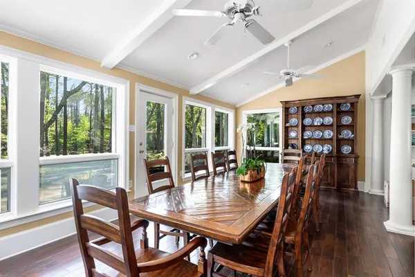 a dining room with furniture a chandelier and wooden floor