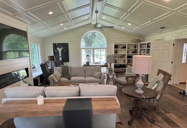 a living room with furniture a window and a chandelier