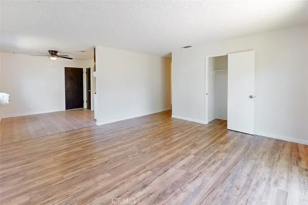 a view of a big room with wooden floor and staircase