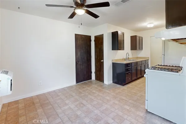 a kitchen with stainless steel appliances a refrigerator and a stove top oven