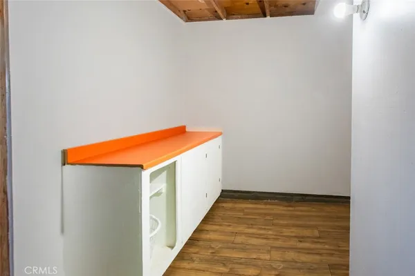 a view of room with wooden floor