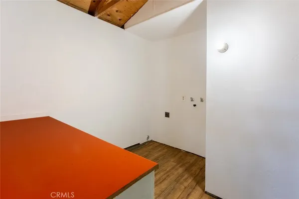 a view of a room with wooden floor and cabinet