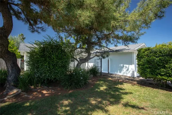 a view of a house with a tree