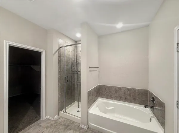 a bathroom with a bathtub and a shower