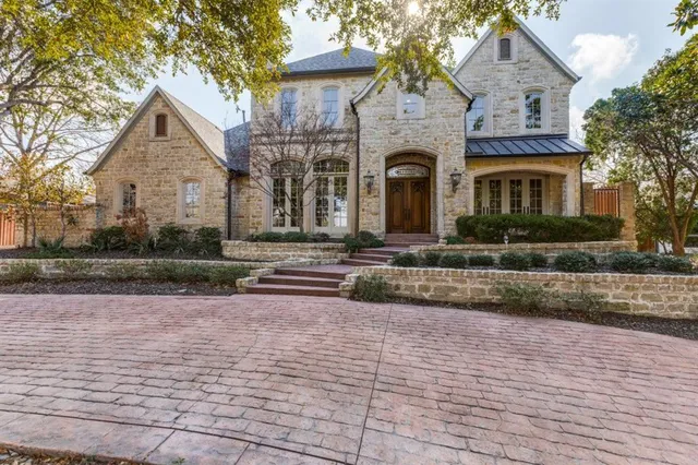 a front view of a house with a yard and a garage