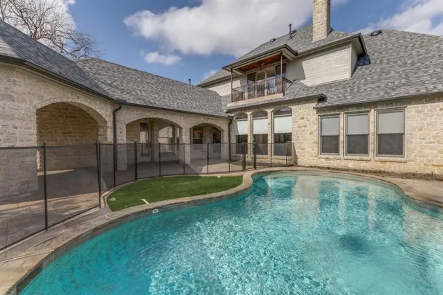 a view of pool with brick walls